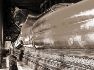 Praying the reclined Buddha, Wat Pho, Bangkok, Thailand (sepia)