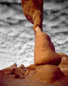 UT, Arches NP Delicate Arch against clouds