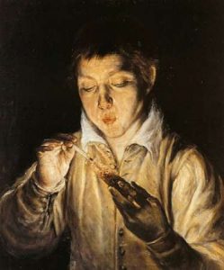 Boy Blowing On An Ember To Light A Candle