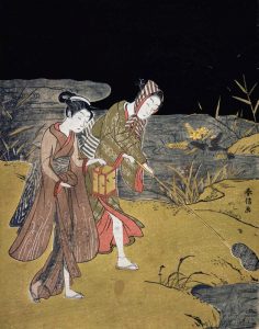 A Young Couple Catching Fireflies at Night On The Banks of a River