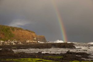 New Zealand, South Island Rainbow over Curio Bay