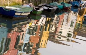Italy, Venice, Burano Row of boats and houses