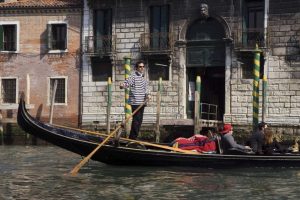 Italy, Venice A gondolier strikes a pose