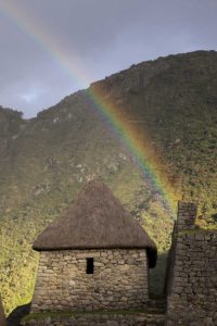 Rainbow over hut at sunset, Machu Picchu, Peru