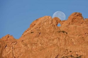 CO, Colorado Springs Moon sets behind formations
