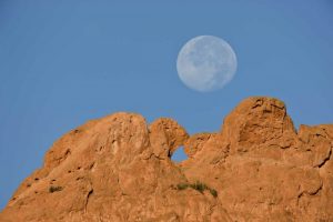 CO, Colorado Springs Moon sets behind formations