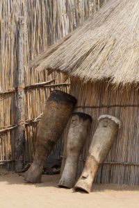 Namibia, Caprivi Strip Tribal drums lean on hut