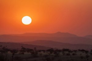 Namibia, Damaraland Orange sunset over mountains