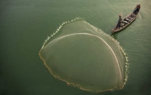 Myanmar, Fisherman casting net on Irrawaddy River